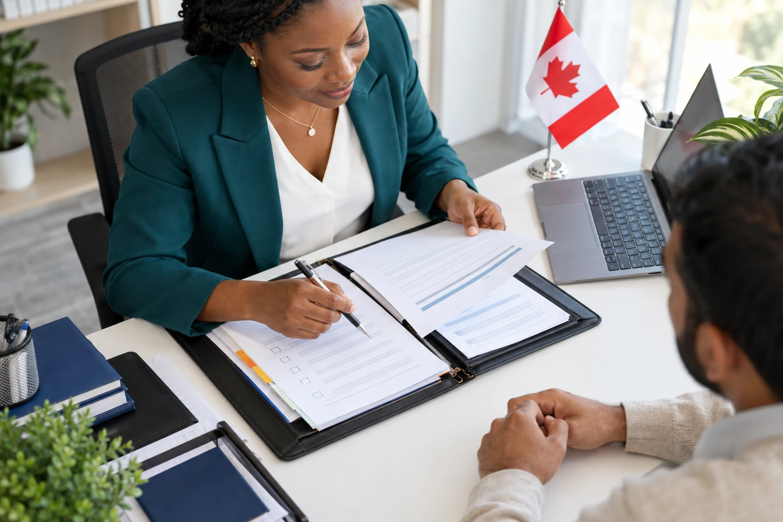 An adviser in a teal blazer reviewing a checklist and application documents